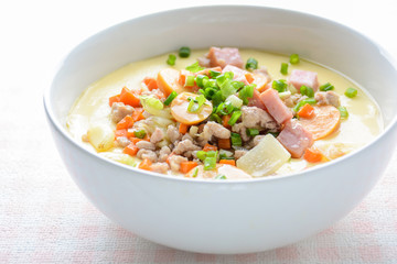 Steamed egg custard cuisine in a white bowl with minced pork, sausage and bacon.  Or Only with egg, water, salt and some sesame oil, you can make this super smooth custard at home. .