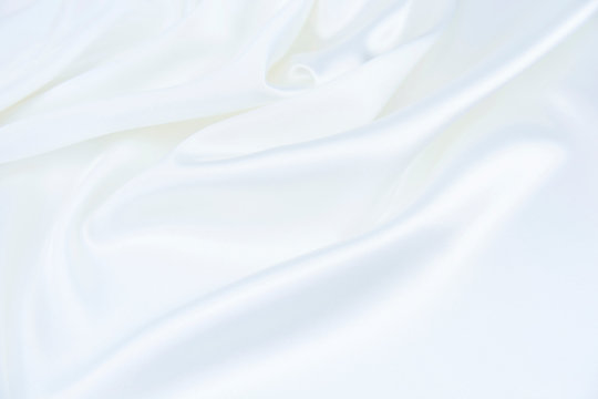 The texture of the satin fabric of white color for the background © Ольга Васильева
