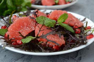  Diet salad with grapefruit, herbs and pomegranate. Gourmet food.