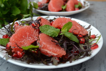  Diet salad with grapefruit, herbs and pomegranate. Gourmet food.