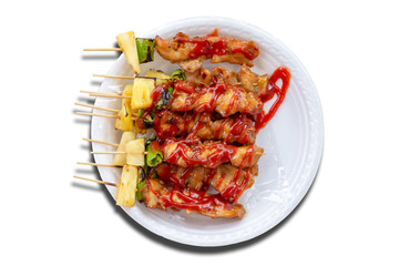 Isolated BBQ grilled Chicken with vegetables and tomato sauces on a white background with clipping path.