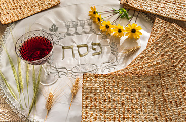 Traditional unleavened bread food - matzah and glass of red wine for Jewish Passover Holiday....