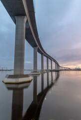 The massive Jordan Bridge over the Elizabeth River in Virginia, reflecting in the water at sunset, in high resolution