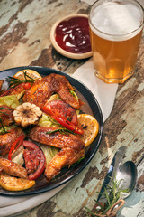 Grilled chicken wings spiced with chili peppers and rosemary