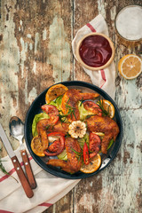 Grilled drumstick of chicken in spicy marinade with the addition of chili