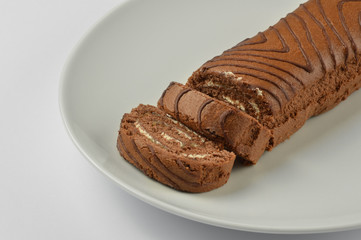 Sliced chocolate sponge cake in a white plate