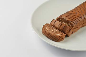 Sliced chocolate sponge cake in a white plate