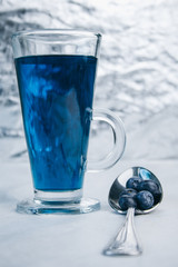 healthy light breakfast. Blue tea from orchids, blueberries on a spoon. close up. proper nutrition for a slim figure. raw food vegetarianism. diet