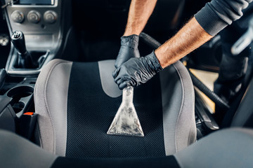 Dry cleaning of car interior with vacuum cleaner