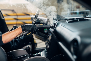 Carwash, removing dust and dirt with steam cleaner