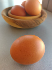 Raw fresh eggs in bowl on white background