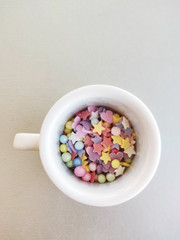 Fototapeta na wymiar Colorful tiny sprinkles shapes in cup
