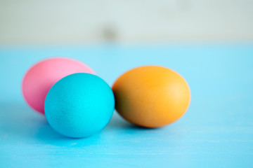 Easter painted eggs on a blue wooden table.  soft focus