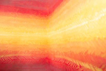 A beautiful smooth transition from red to yellow and back. Gdaddientny background with visible brush strokes. Brush strokes form herringbone pattern. Joyful bright multicolored backdrop.