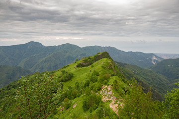 Panoramic view of the valleys of the Apuan Alps, on a cloudy spring day.