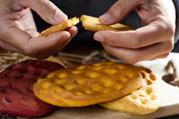 man splitting a piece of an italian focaccia.