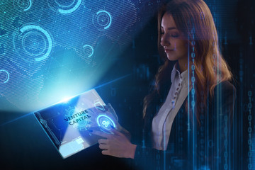 The concept of business, technology, the Internet and the network. A young entrepreneur working on a virtual screen of the future and sees the inscription: Venture capital