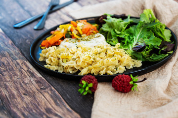 cod fish with vegetables, small vegetables and marine sauce