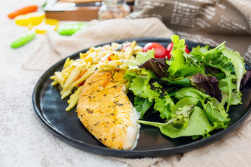 close-up of plate of pasta and chicken with lettuce