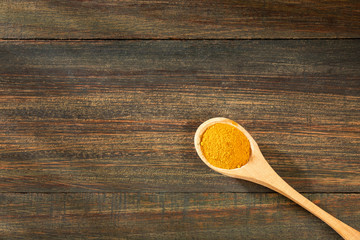 Organic turmeric powder - Curcuma longa. Wood background