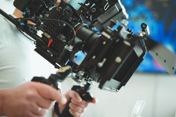 Operator working with his video camera in apartment