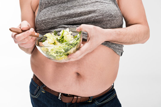 Cropped View Of Overweight Man Holding Bowl Of Salad Isolated On White