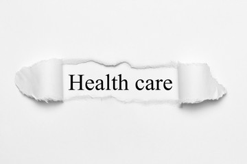 Health care on white torn paper
