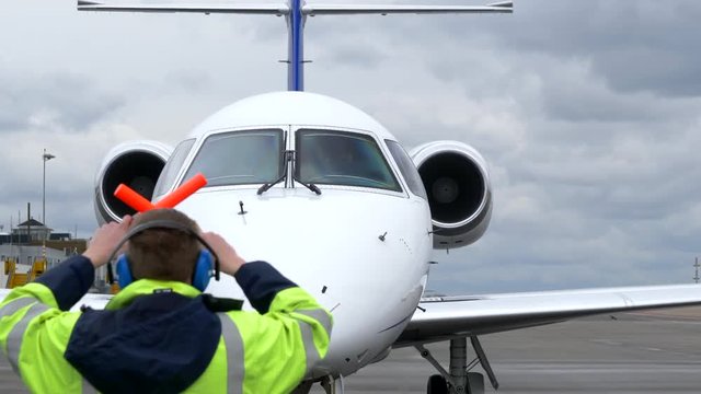 Airport Air Marshaller Signalling Executive Jet Pilot.