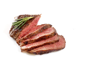 Grilled beef steak, sliced, isolated on white background.