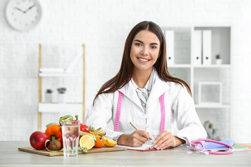 Portrait of female nutritionist in her office - obrazy, fototapety, plakaty