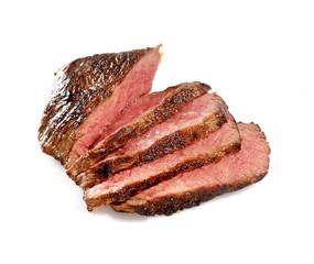 Grilled beef steak, sliced, isolated on white background.