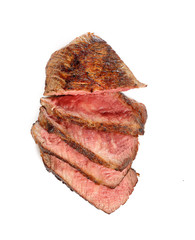 Grilled beef steak, sliced, isolated on white background.