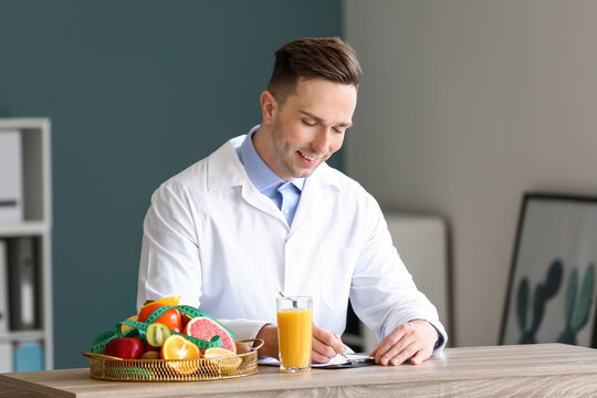 Male nutritionist working in his office Stock Photo | Adobe Stock