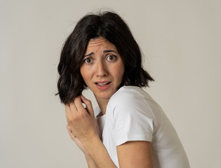 Portrait of a young attractive woman looking scared and shocked.Human expressions and emotions