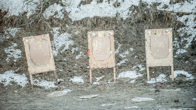 Shooting range target after shooting with shotgun bullet gauge pellets