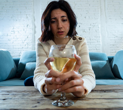 Portrait of sad, unhappy, helpless woman drinking wine. Human emotions, depression and alcoholism