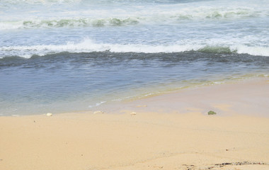 waves on the beach with beautiful white sand and blue sky background