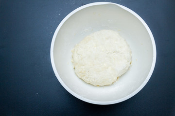 Raw mixed dough lies in a mixing bowl