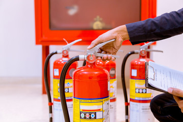 Male Professional inspection Fire extinguisher,safety concept.