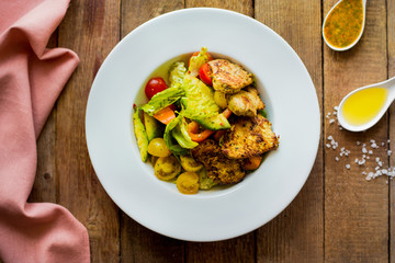 Chicken salad with vegetables and cherry. Homemade. Top view. Wooden. 