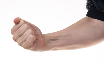 A closeup view on the arm and clenched fist and raised tendons of a Caucasian man isolated against a white background