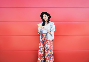 Happy Asian girl using mobile phone outdoor - Chinese social influencer having fun with new trends...