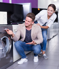 Family couple selecting new clothes washer