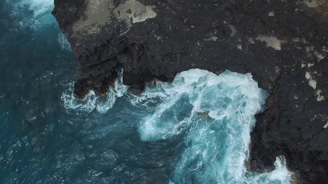 Aerial: Rocky Shore With Crashing Waves From Blue Ocean in Big Island, Hawaii