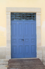 Fototapeta na wymiar blue wooden front door with metal lattice 