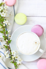coffee and macaron in white wood background spring breakfast