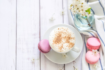 coffee and macaron in white wood background spring breakfast
