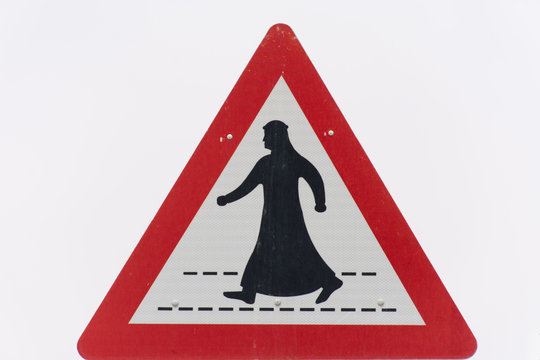 Man in Kandora Crossing the street sign in the United Arab Emirates (UAE).