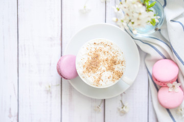 Obraz na płótnie Canvas coffee and macaron in white wood background spring breakfast