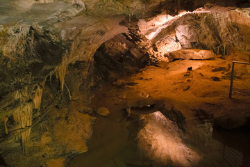 A footbridge allows you to visit the beautiful rock formations of the Antro del Monte Corchia cave in the Apuan Alps in Italy.